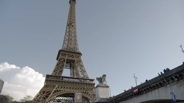 Paris. France. 11-29-2023. Low view. Famous eiffel tower. Sunny day. City of Paris. Tilt 4K
