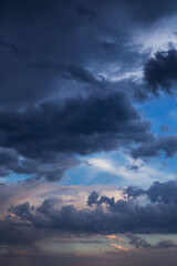 Epic Dramatic storm dark blue grey cumulus rain clouds on blue sky background, thunderstorm