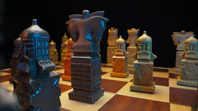 Slavic old styled chess pieces on wooden chessboard before party competition. Board strategy game. Teamwork, success business, intelligence sport concept. Slider macro shot.