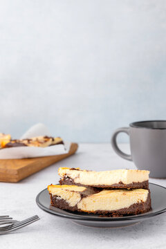 Breakfast time. Tasty baked cheesecak with cacao powder, cup of coffee.Vertical image