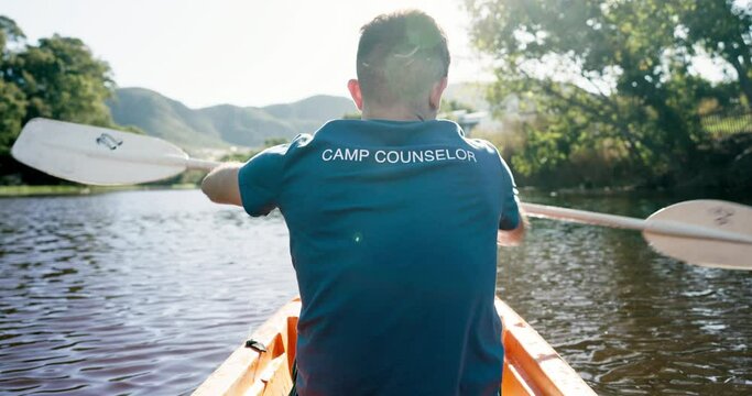 Lake, camping and man in kayak from back, rowing and summer adventure in nature for sports, fun and hobby. Row boat, canoe and camp counsellor on river in trees, water and freedom on outdoor vacation