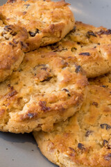 Coconut Cranberry and raisin Cookies on a Grey China plate