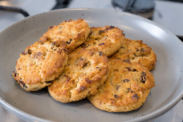 Coconut Cranberry and raisin Cookies on a Grey China plate