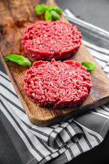 ground meat raw cutlet fresh beef meat hamburger eating cooking appetizer meal food snack on the...