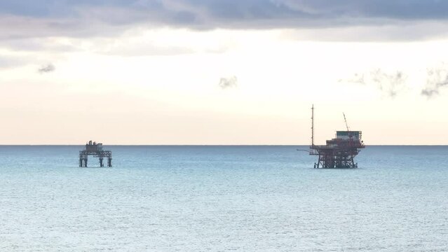Drilling rig for gas extraction in the Adriatic Sea at sunrise