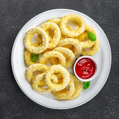 onion rings batter deep fryer tomato sauce fast food eating cooking appetizer meal food snack on the table copy space food background rustic top view