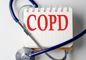 COPD word on notebook with medical equipment on background