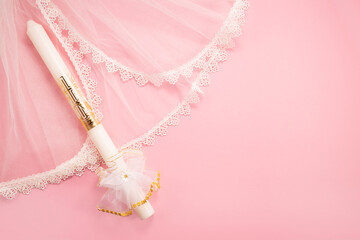 Christening background with baptism baby dress and candle on pink background. - obrazy, fototapety, plakaty