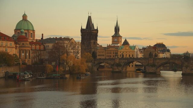 landscape with Vltava river and Charles Bridge at sundown in autumn in Prague, Czech Republic.