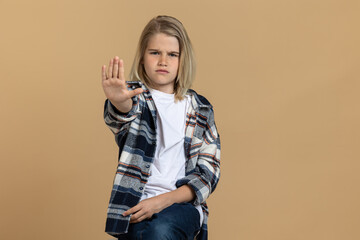 Teen girl putting hands up in a rejecting gesture