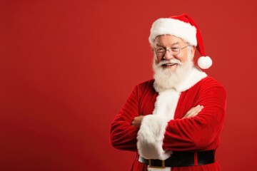 Fototapeta na wymiar Cheerful elderly man dressed as Santa Claus celebrates Christmas with a warm and festive gesture.