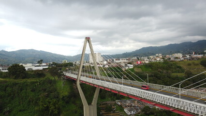 Pereira's iconic bridge stands as a testament to urban growth against a backdrop of city life.