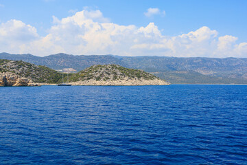 View of the rocky shore from the sea. Mediterranean Sea in Turkey. Popular tourist places. Background