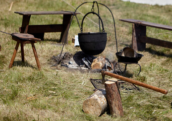 Camping. Soup in a pot over a fire.