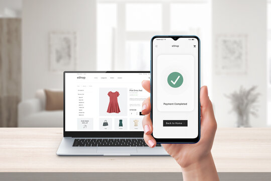 Phone online payment. Laptop and e-commerce website in background. Digital transaction showcasing seamless online shopping and secure electronic payments