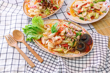 Mix Seafood salad with preserved egg. Spicy salad. Thai style.