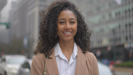 Young black business woman smiling face portrait on city street