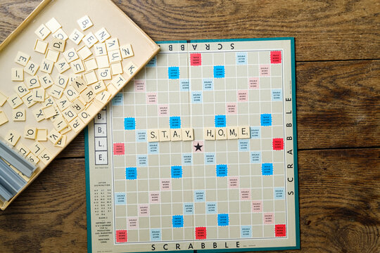  Scrabble game board and Stay Home sign. Leisure concept during quarantine self-isolation, February 12, 2021
