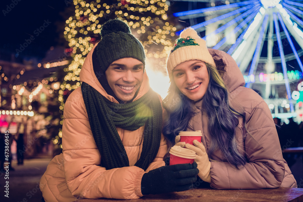 Canvas Prints Photo of good mood pretty african guy lady dressed coats enjoying x-mas eggnog together outdoors urban ferris wheel fair park