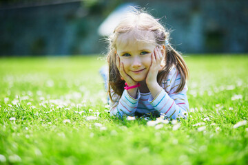 Happy cheerful preschool girl walking in park