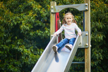 Adorable little girl on playground on a sunny day