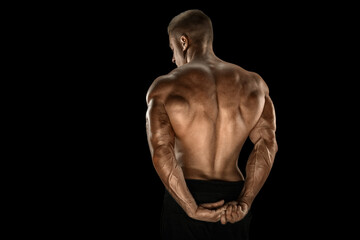 Fototapeta na wymiar Handsome power bodybuilder showing his back