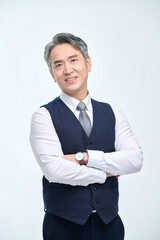 A middle-aged man in a suit is doing various facial expressions and hand movements.