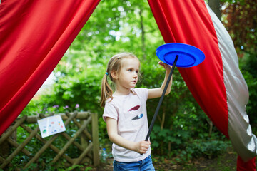 Preschooler girl practicing spinning circus skills © Ekaterina Pokrovsky