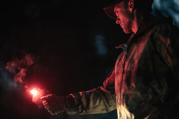A Man with Burning Emergency Flare in His Hand