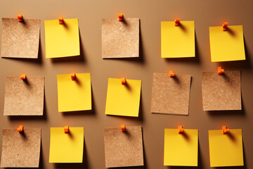 Yellow sticky notes pinned on board in rows - obrazy, fototapety, plakaty