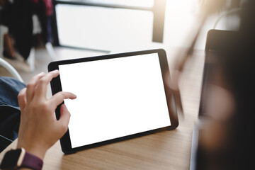 A woman hand showing digital tablet blank screen on work desk..