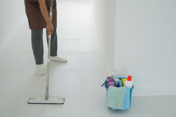 Woman, housewife mopping floor at home.