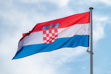 The national flag of Croatia waving in the blue sky