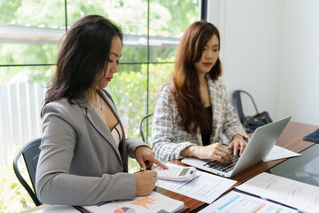 Businesswoman Accountant analyzing investment charts Invoice and pressing calculator buttons over documents. Accounting Bookkeeper Clerk Bank Advisor And Auditor