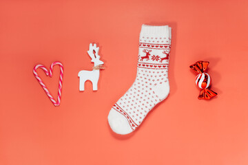 Minimalist Christmas mood concept. Red Background with Christmas attributes as candy canes in the...