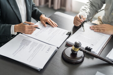 Lawyer Legal counsel presents to the client a signed contract with gavel and legal law. justice and lawyer Business partnership meeting concept - obrazy, fototapety, plakaty