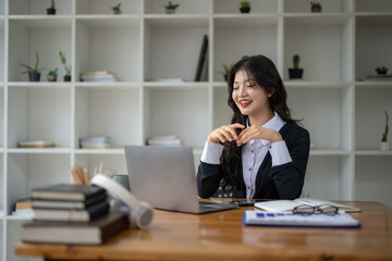 Freelance Asian woman enjoying video call on her laptop Remote work and communications.
