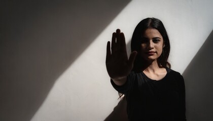 Human Rights Day Concept: Woman with her hand extended signaling to stop useful to campaign against violence, gender or racial, discrimination - obrazy, fototapety, plakaty