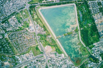 an aerial view of a small city surrounded by land and trees