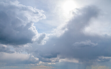White fluffy clouds, sun and blue sky. Majestic view in summer.