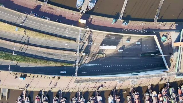 Drone shot over NEMO Science Museum, IJ tunnel and Valkenburgerstraat street. Amsterdam, Netherlands