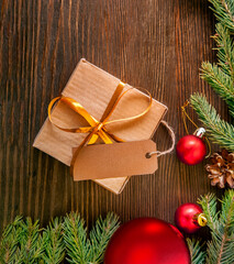 Christmas tree with gift box and decorations on wooden background