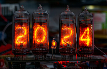 retro Nixie lamp indicator clock on dark background 2024 number