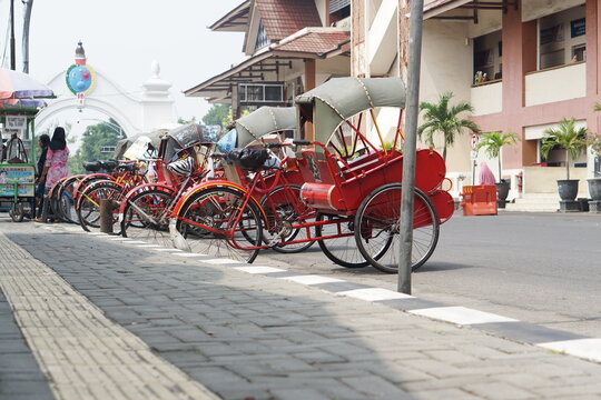 A simple means of transportation (becak) is parked in the Malioboro area of ​​Yogyakarta.