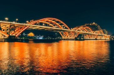 Scenic view of Wenhui Bridge with its bright night illumination. Liuzhou, China.