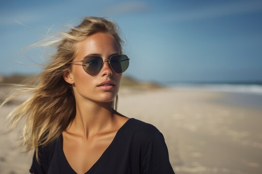 Side view closeup of young woman with sunglasses enjoying sunlight against sky at beach