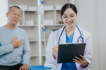 Fototapeta premium Female doctor talking taking care of her senior patient give support Doctor helping elderly patient with Alzheimer's disease A female attendant holds the hand of an elderly man