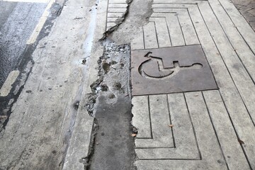 Damaged sidewalk wheelchair ramp