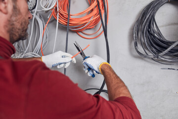 Electrician working on a wire system on a construction site.