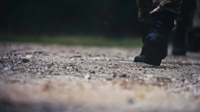 Soldiers' Boots Tread on Puddles